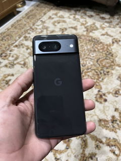 Buyer’s photo: back of a black Pixel 8, held in hand