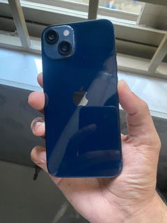 Buyer’s photo: back of a dark blue iPhone 13, held in hand