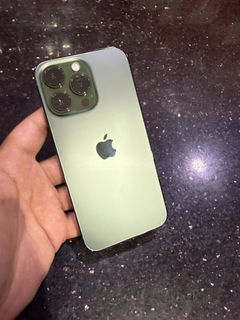 Buyer’s photo: back of a green iPhone 13 Pro, held in hand