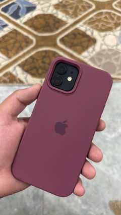 Buyer’s photo: iPhone 12 in a plum silicone case, held in hand